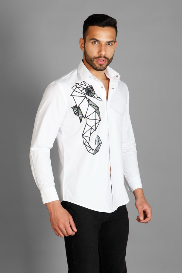 A white crisp cotton men's shirt with abstract big sea horse print detailed with metallic silver highlights on the print. The shirt is handcrafted for a regular fit style. Shop statement looks at Just Billi. 