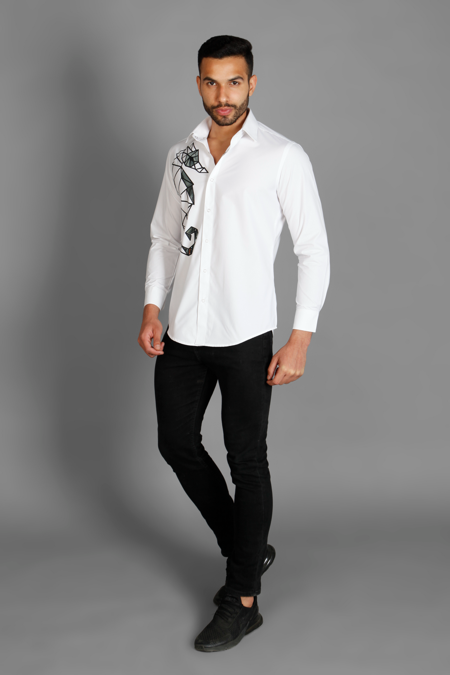 A white crisp cotton men's shirt with abstract big sea horse print detailed with metallic silver highlights on the print. The shirt is handcrafted for a regular fit style. Shop statement looks at Just Billi. 