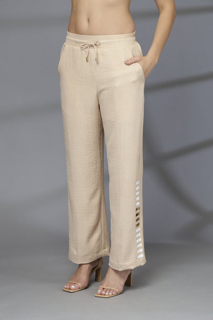 Beige pants worn by a person on a gray background