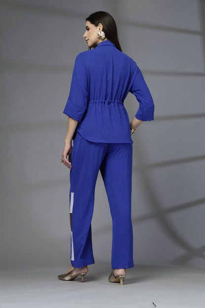 Woman wearing a blue outfit with a gray background