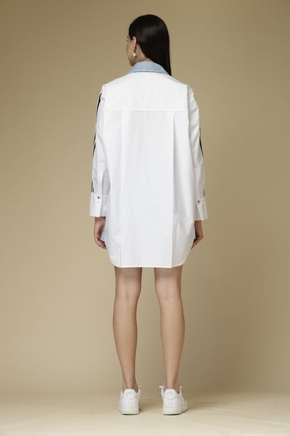 Person wearing a white lab coat on a beige background