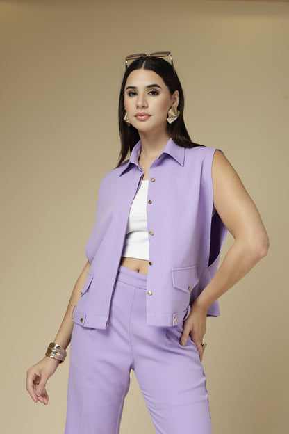 Woman wearing a light purple outfit with a beige background