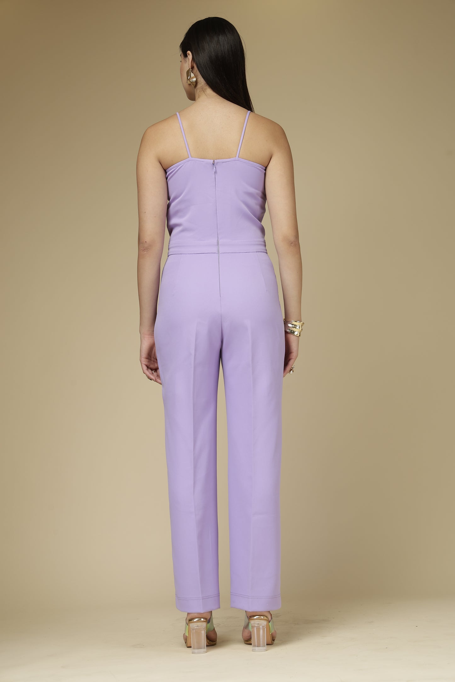 Person wearing a purple outfit against a beige background