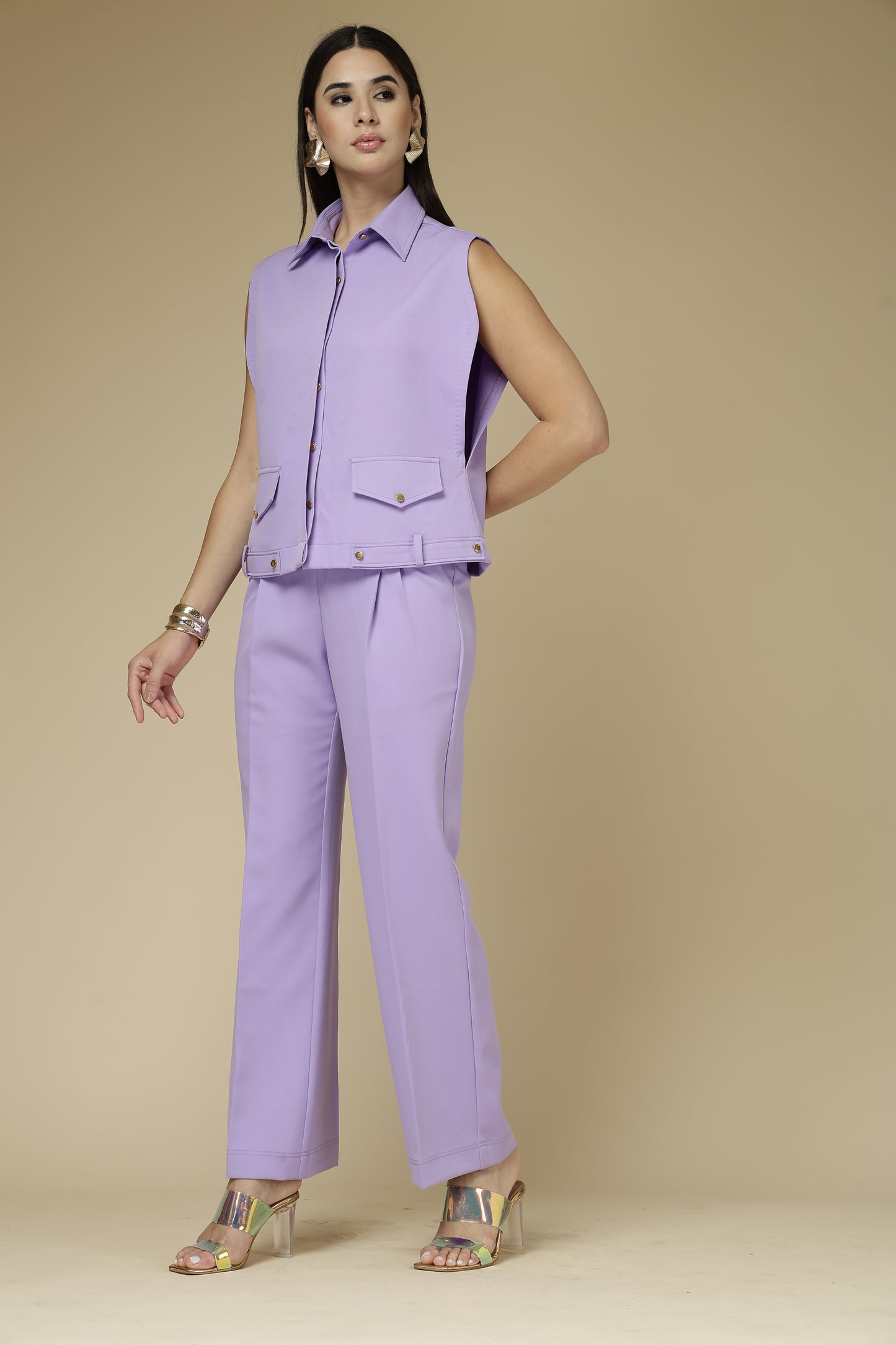 Woman wearing a purple outfit against a beige background