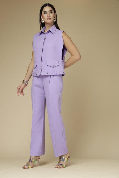 Woman wearing a purple outfit against a beige background
