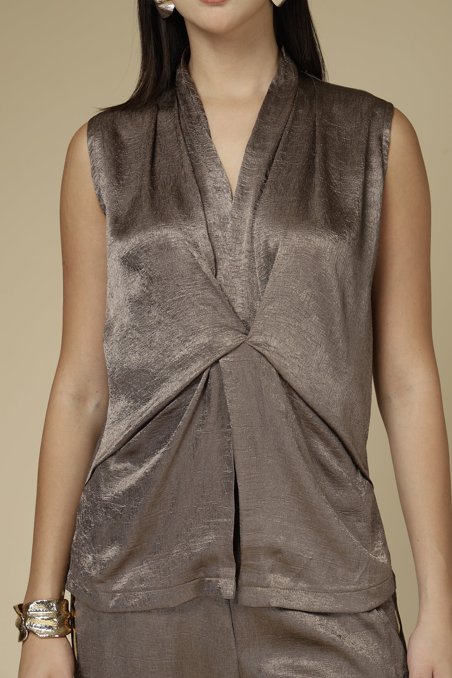 Brown velvet dress with a knot detail on a beige background