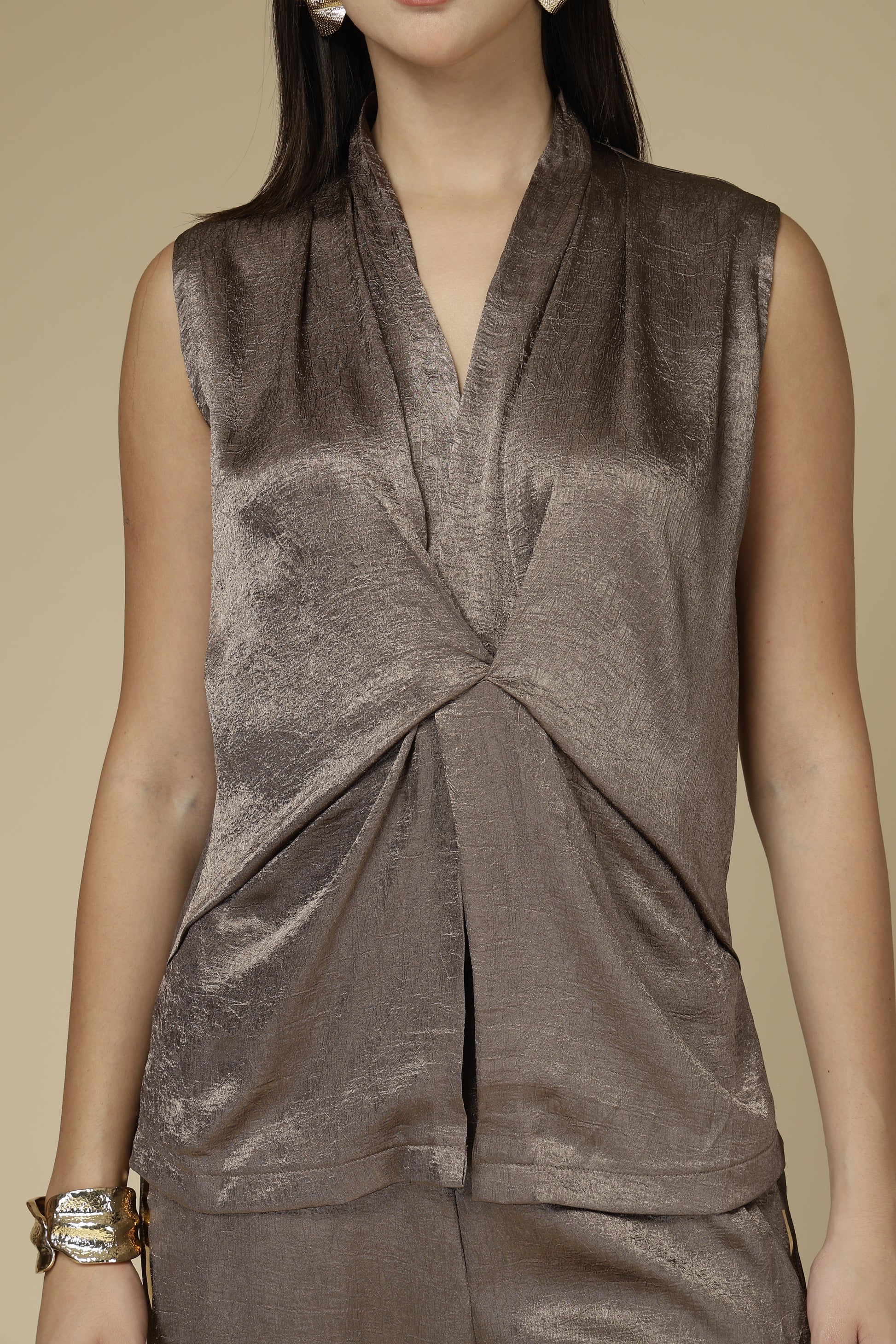 Brown velvet dress with a knot detail on a beige background
