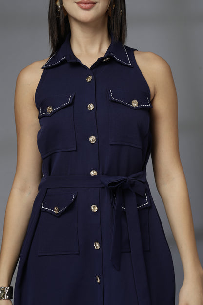 Navy blue sleeveless dress with button details on a gray background