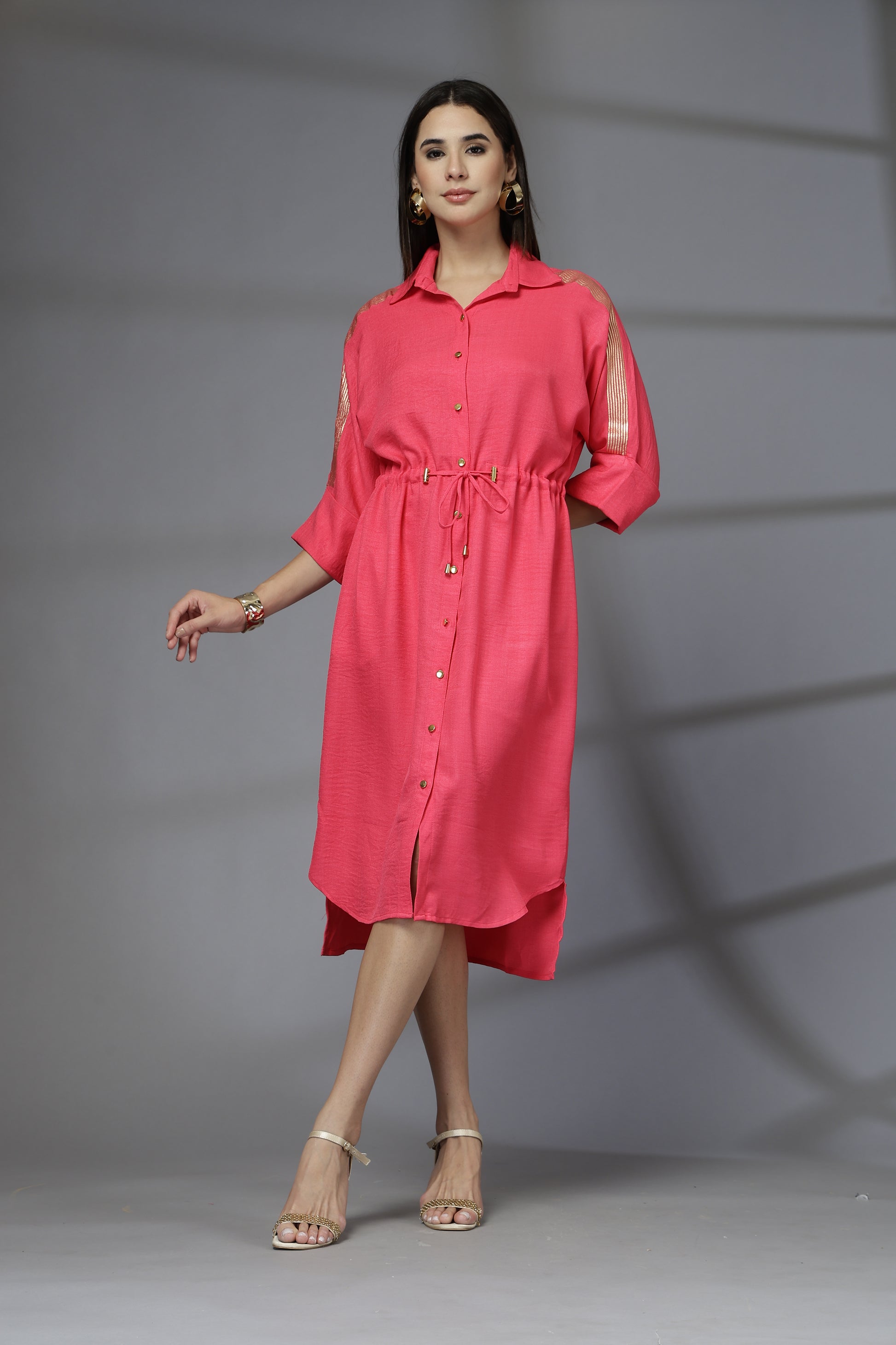 Woman wearing a red dress against a gray background