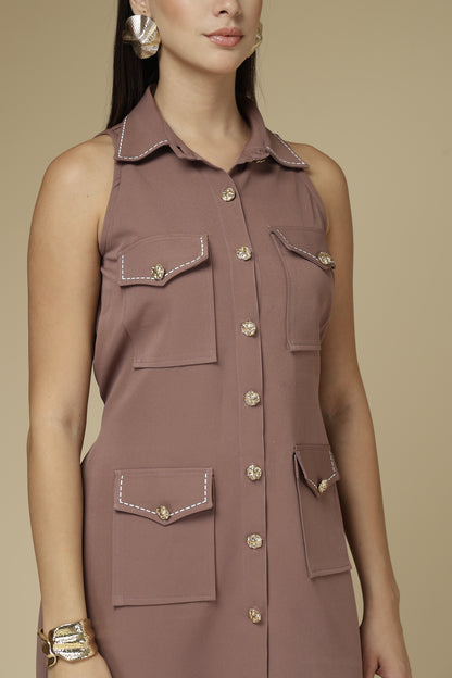 Brown sleeveless dress with button details on a beige background
