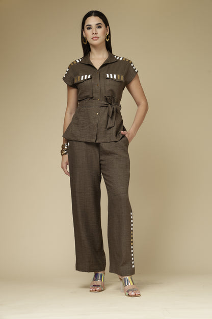 Woman wearing a brown outfit with a beige background