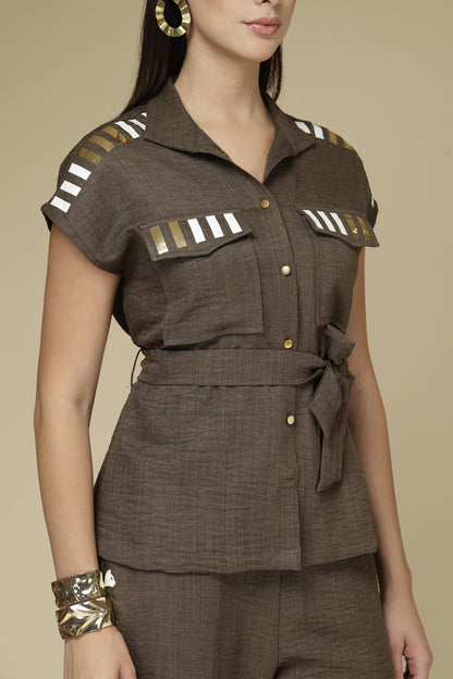 Brown outfit with decorative elements on a beige background